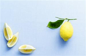 Lemon wedges and lemon with leaf