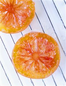 Candied citrus fruit slices on draining rack