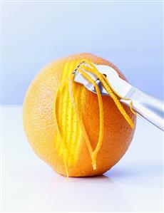 Cutting orange zest with a zest