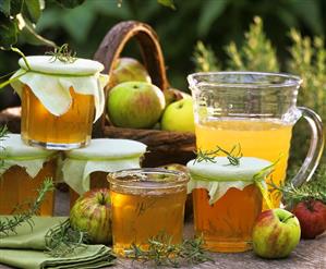 Still life with apple jelly, apples and rosemary