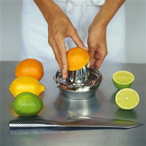 Citrus fruits, half an orange on lemon squeezer