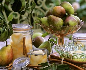 Fresh and bottled pears with cinnamon sticks