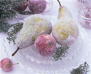 Sugared pears and apples on crystal glass plate