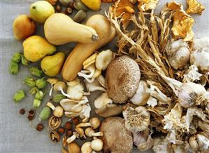 Autumn still life with vegetables, mushrooms, fruit & nuts