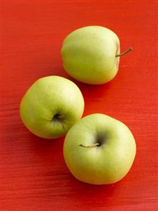 Three Golden Delicious apples