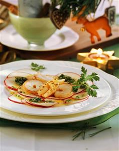 Shrimp carpaccio with thin apple slices and parsley pesto