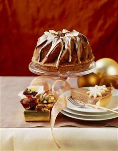 A piece of chocolate mousse cake, gugelhupf in background