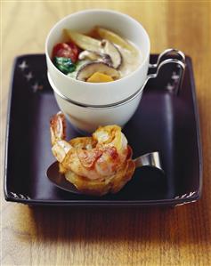 Asian coconut cream soup with bacon-wrapped prawn on toast