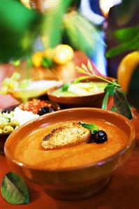 Creamed tomato soup with toasted bread and olive