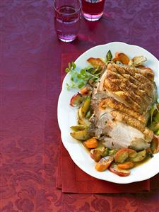 Roast pork with crackling with apples and vegetables