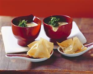 Curried fennel soup with oyster won ton on spoon