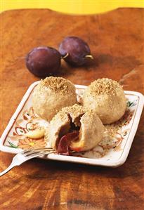 Plum dumplings with nut sprinkles