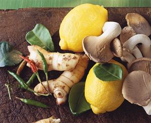 Still life with lemons, mushrooms and chili peppers