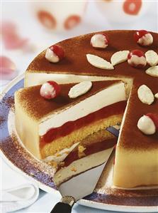 Cherry and marzipan cake, partly sliced