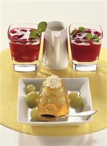 Grape and gooseberry jelly and red berry compote with cream