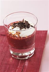 Apple and plum dessert with cream, chocolate and praline