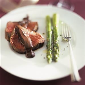 Beef fillet with chocolate sauce and green asparagus