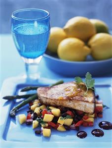 Fish steak on fruity vegetable salad