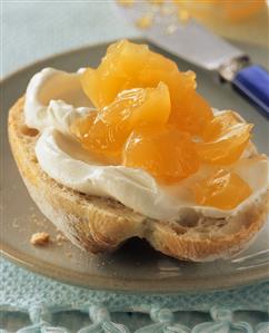 Passion fruit and orange jelly on a roll with fresh cheese