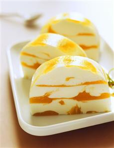 Slices of yoghurt and mango terrine on a plate