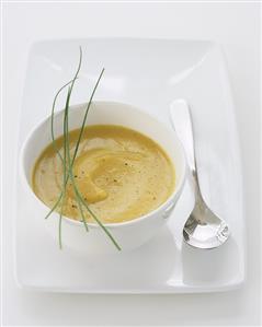 Pumpkin soup in a soup bowl with spoon