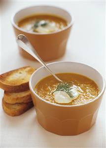 Creamed vegetable soup with a blob of cream and toasted bread