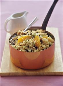 Couscous salad with orange segments and sultanas in pan