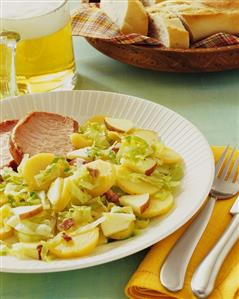 Potato and cabbage salad with apple, served with smoked pork