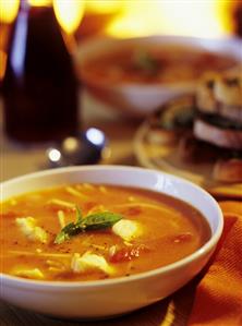 Fish and tomato soup in a soup plate