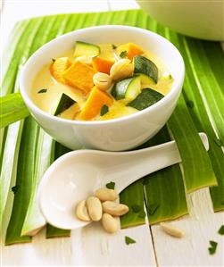 Vietnamese pumpkin soup with cashew kernels and courgettes