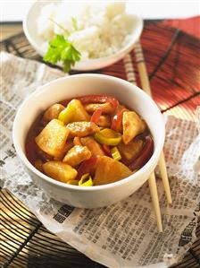 Chicken, pineapple and vegetables cooked in wok (China)