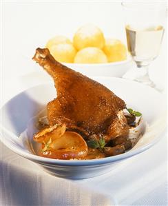 Goose leg with apple slices, chestnuts & potato dumplings