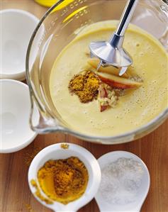 Pureeing carrot and ginger soup with apple pieces