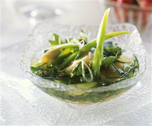 Soup with ravioli and green vegetables