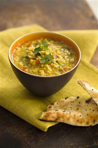 A bowl of curried lentil soup with coriander