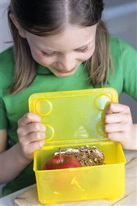 Girl packing up a packed lunch