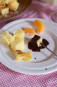 Chocolate fondue with white bread and mandarin oranges