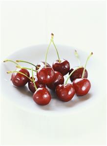 Several cherries on a plate