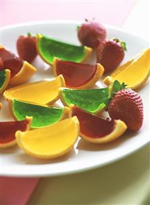 Assorted fruit jellies and strawberries