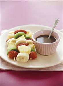 Three fruit skewers and chocolate sauce