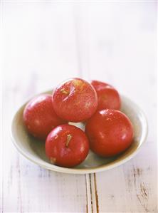 Five plums in a dish