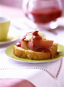 Piece of Madeira cake with nectarines & strawberry sauce