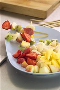 Putting fruit on skewers