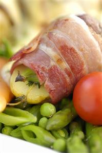 Potatoes and bacon-wrapped figs with vegetables