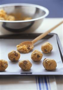 Putting chocolate chip cookies on baking tray