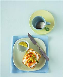 Wholemeal roll with soft cheese and papaya and teacup