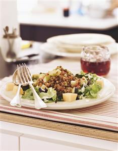 Lentil salad with apple and cheese on salad leaves