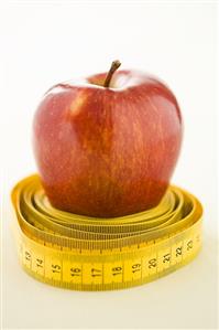 A tape measure around an apple