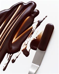 Melted chocolate icing on a palette knife