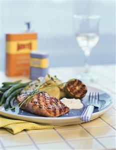 Grilled salmon steak with beans and fried potatoes